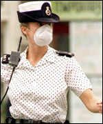 Police woman with anti-fume mask